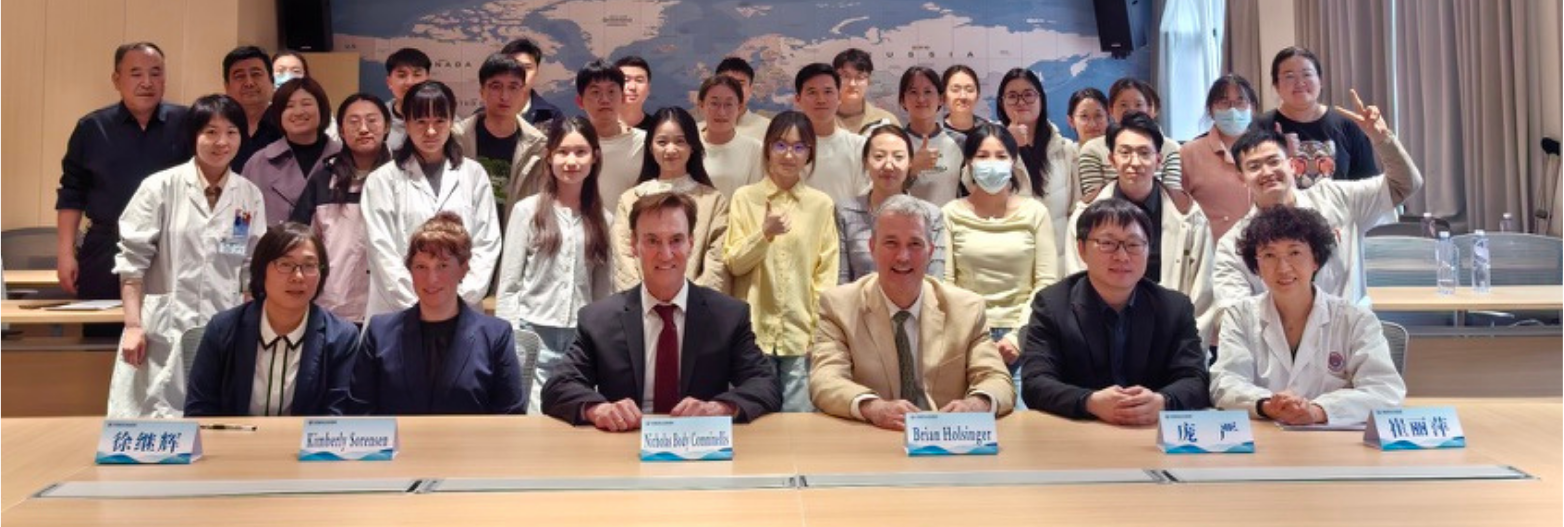 Group photo of students, faculty, and guests at an academic healthcare event.