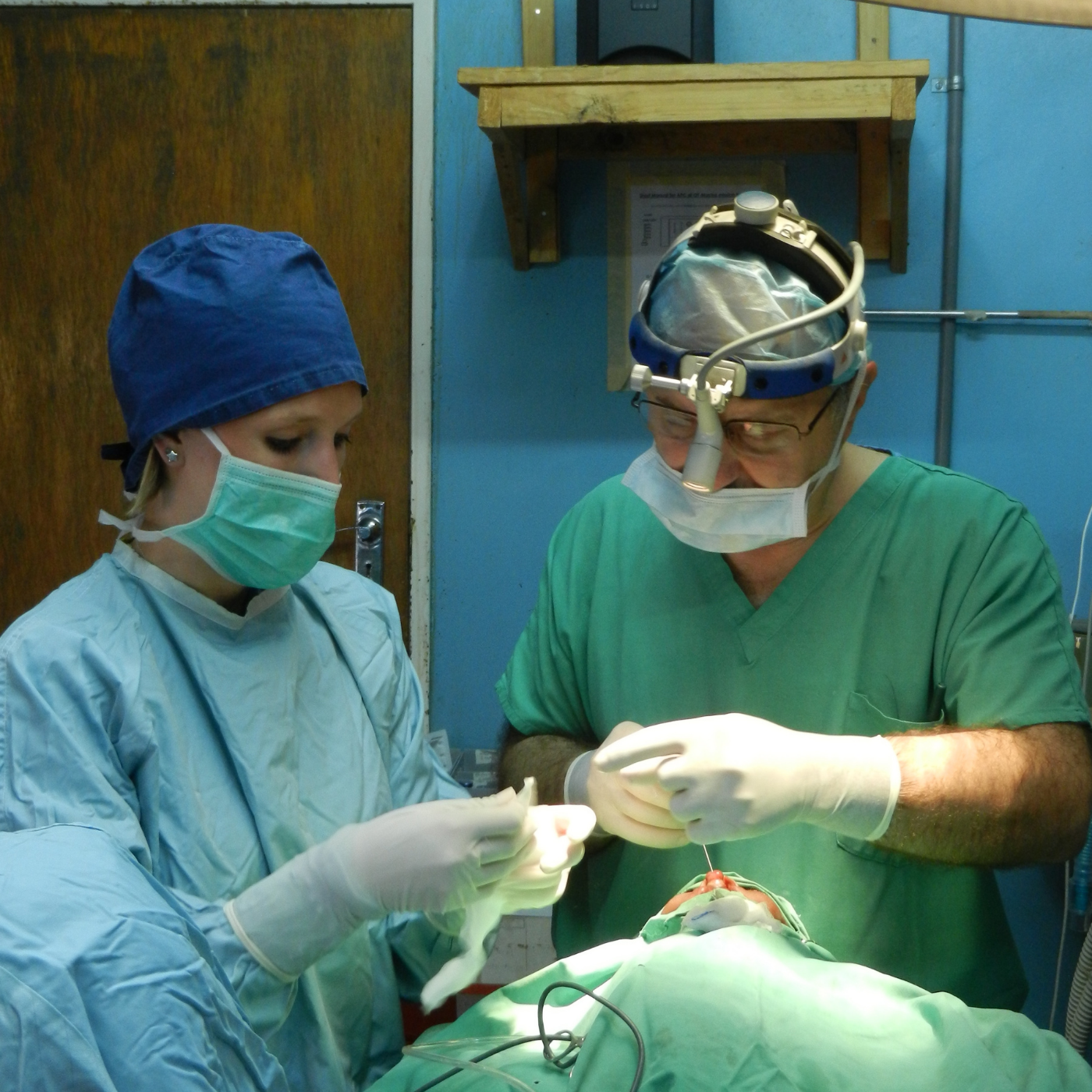 Medical team performing a surgical procedure in an operating room.