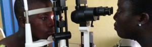 Eye examination being performed using ophthalmology equipment.
