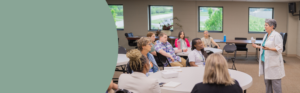 A group of healthcare professionals and students attending a conference breakout session.