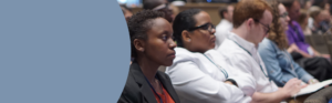 A group of healthcare students listening to plenary session.