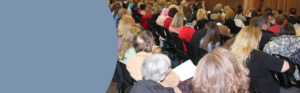 A group of healthcare professionals and students listening to plenary session.