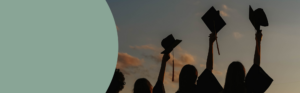 Graduates holding caps during a commencement celebration.