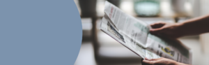 Two hands holding a newspaper.