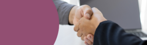 Two individuals shaking hands.