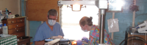 Healthcare professionals providing clinical care in a hospital procedure room.