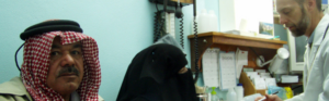 Healthcare provider conducting a patient consultation in a primary care clinic.