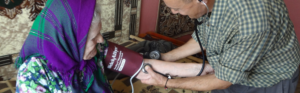 Healthcare provider performing a patient assessment during a community-based clinical visit.