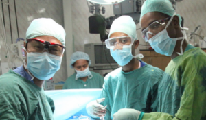 Healthcare professionals posing for a photo right before surgery.