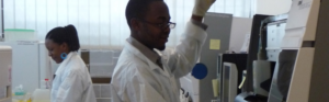 Healthcare professionals working with diagnostic laboratory equipment in a hospital laboratory.