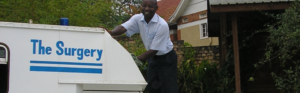 Community healthcare provider preparing a vehicle used for mobile healthcare and outreach services.