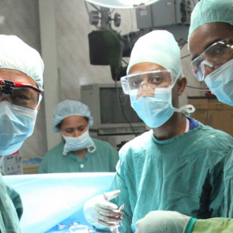 Healthcare professionals posing for a photo right before surgery.